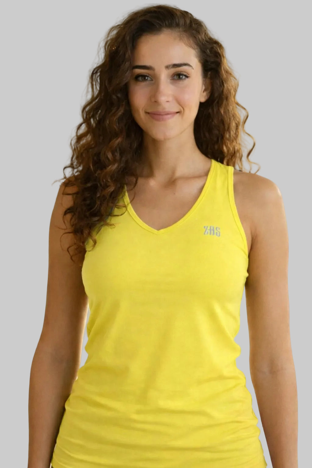 Top femenino de pádel color amarillo zas.